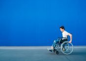 A young gug in a wheelchair rides very fast